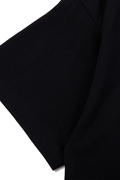 Close-up of black t-shirt sleeve on a white background