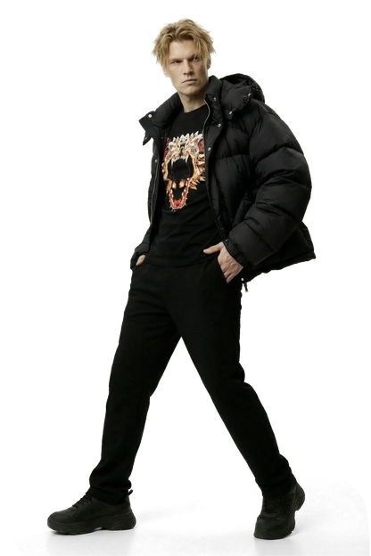 Man wearing a black jacket, black pants, and a black shirt with a dragon graphic design on a white background