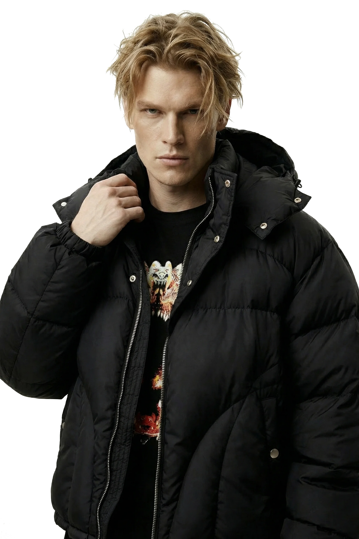 Man wearing a black puffer jacket over a graphic t-shirt on a transparent background
