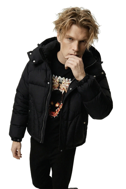 Person wearing a black jacket and 'Ominous' luxury brand dragon graphic t-shirt with a white background.