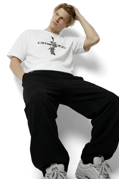 Ominous chrome silver girl heavyweight oversized tee - Person wearing a white t-shirt with text and black pants on a white background