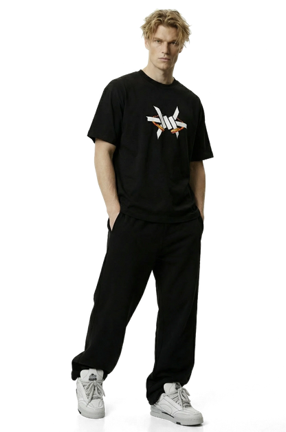 Ominous Fireball Heavyweight Oversized Tee - Person wearing a black t-shirt with a logo and black pants on a white background