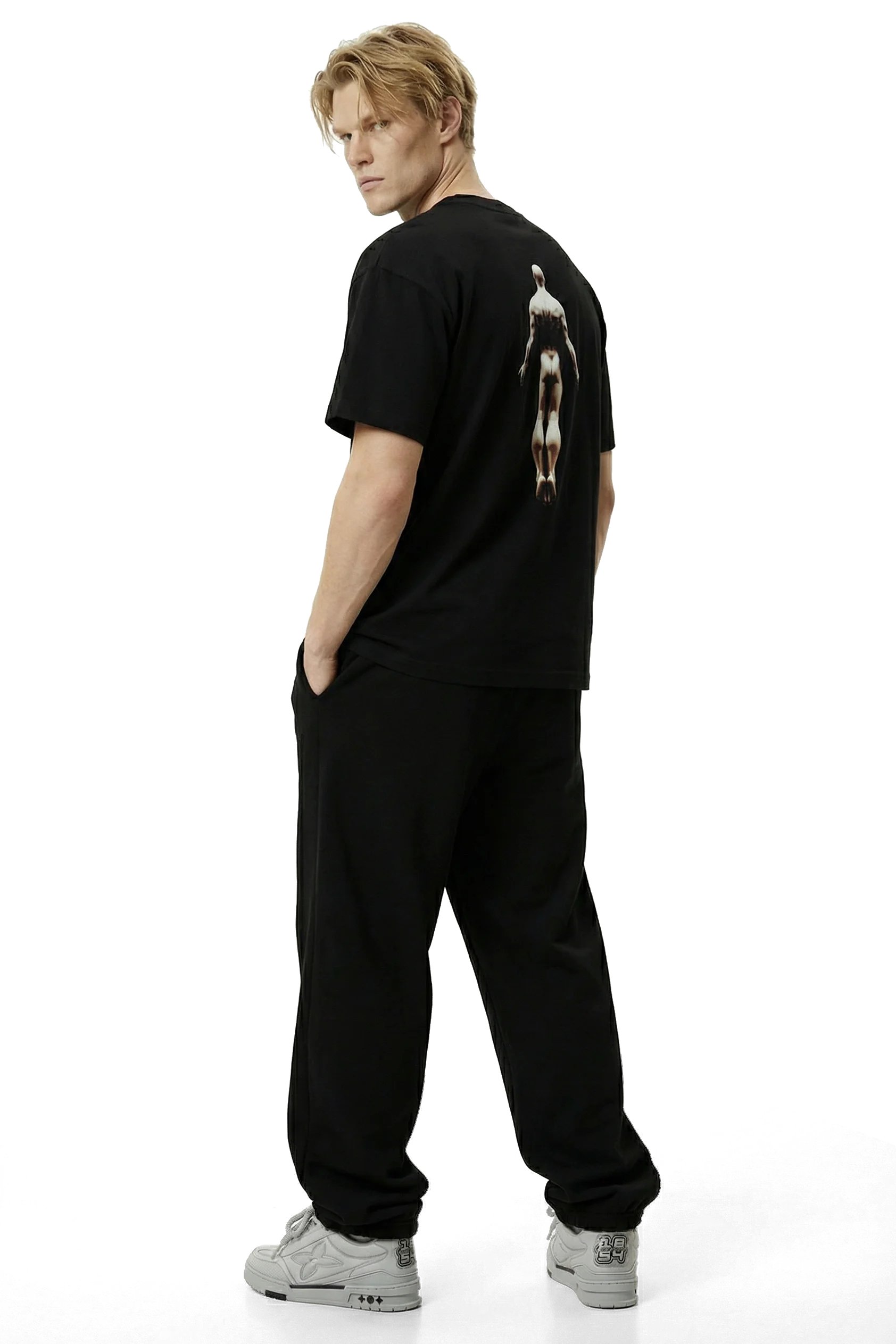 Ominous Ascendance Heavyweight Tee - Person wearing a black t-shirt with a graphic on the back and black pants on a white background