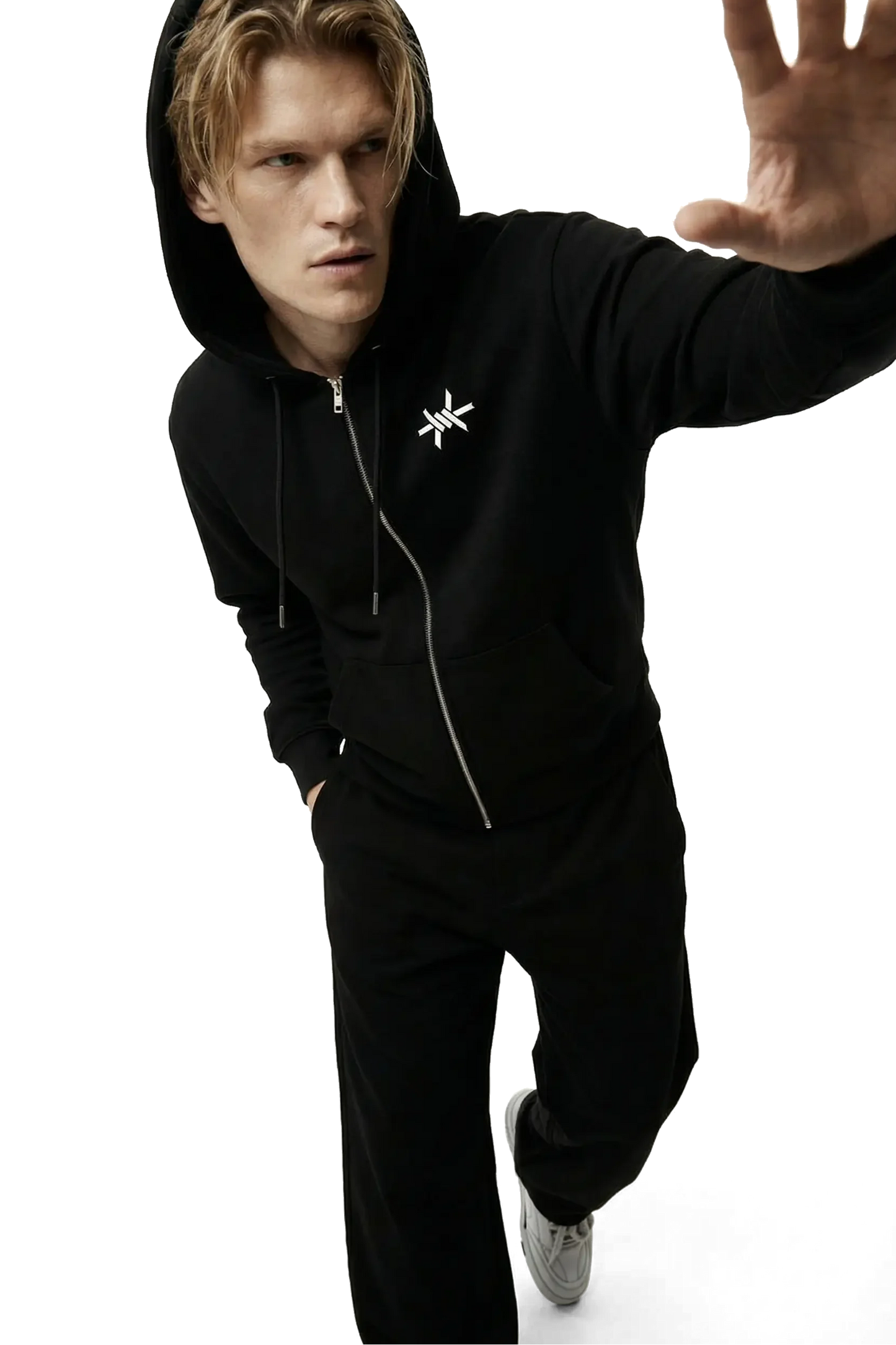 Person wearing a black hoodie with a star 'Ominous' barbed wire logo on a white background