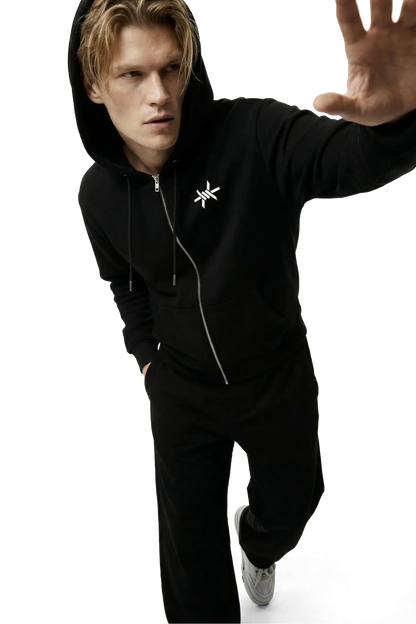 Person wearing a black hoodie with a star 'Ominous' barbed wire logo on a white background