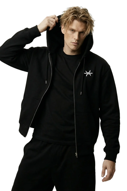 Man wearing a black hoodie with a small 'Ominous' logo on the left chest on a white background