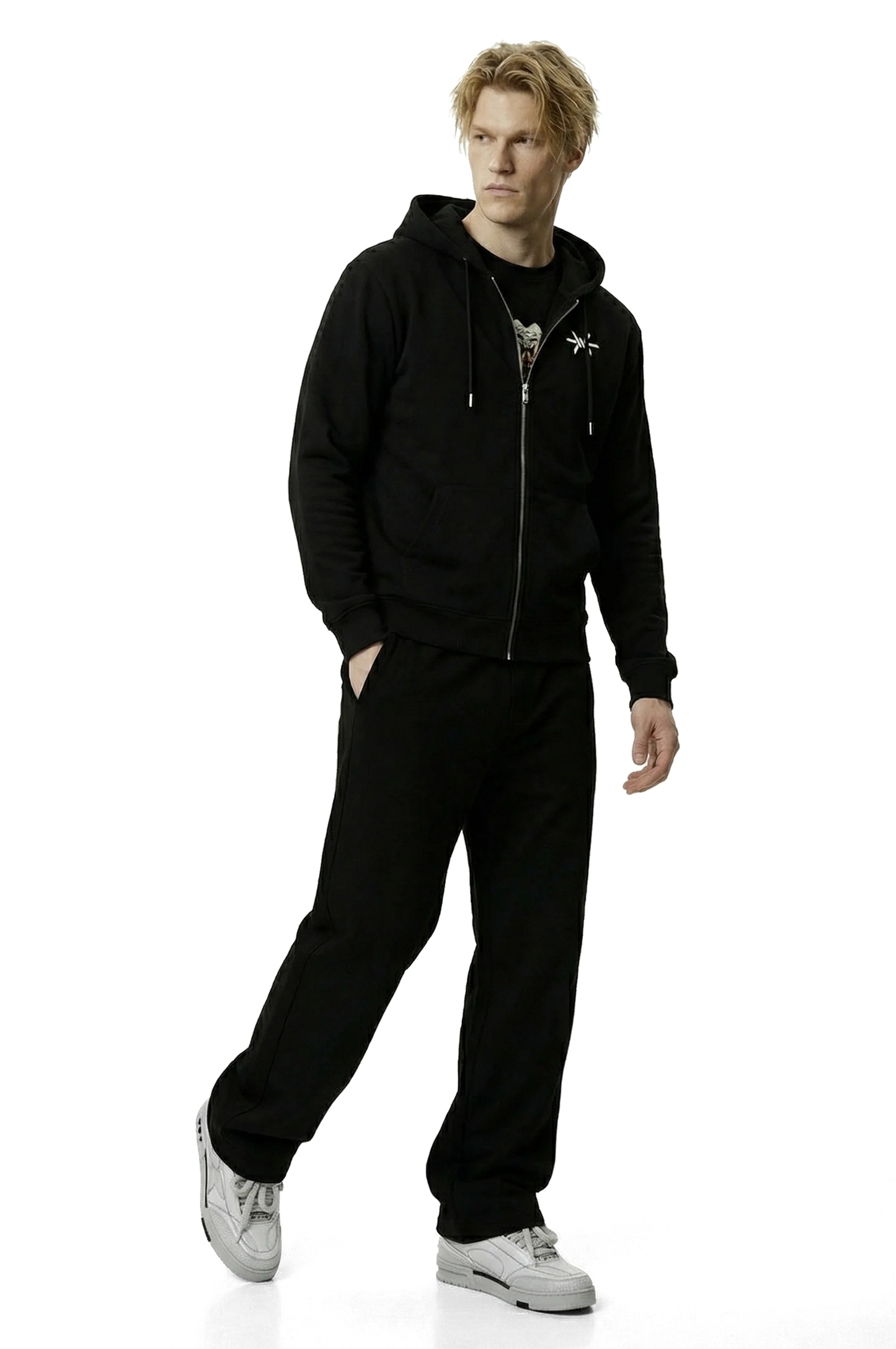 Person wearing a black hoodie and pants on a white background