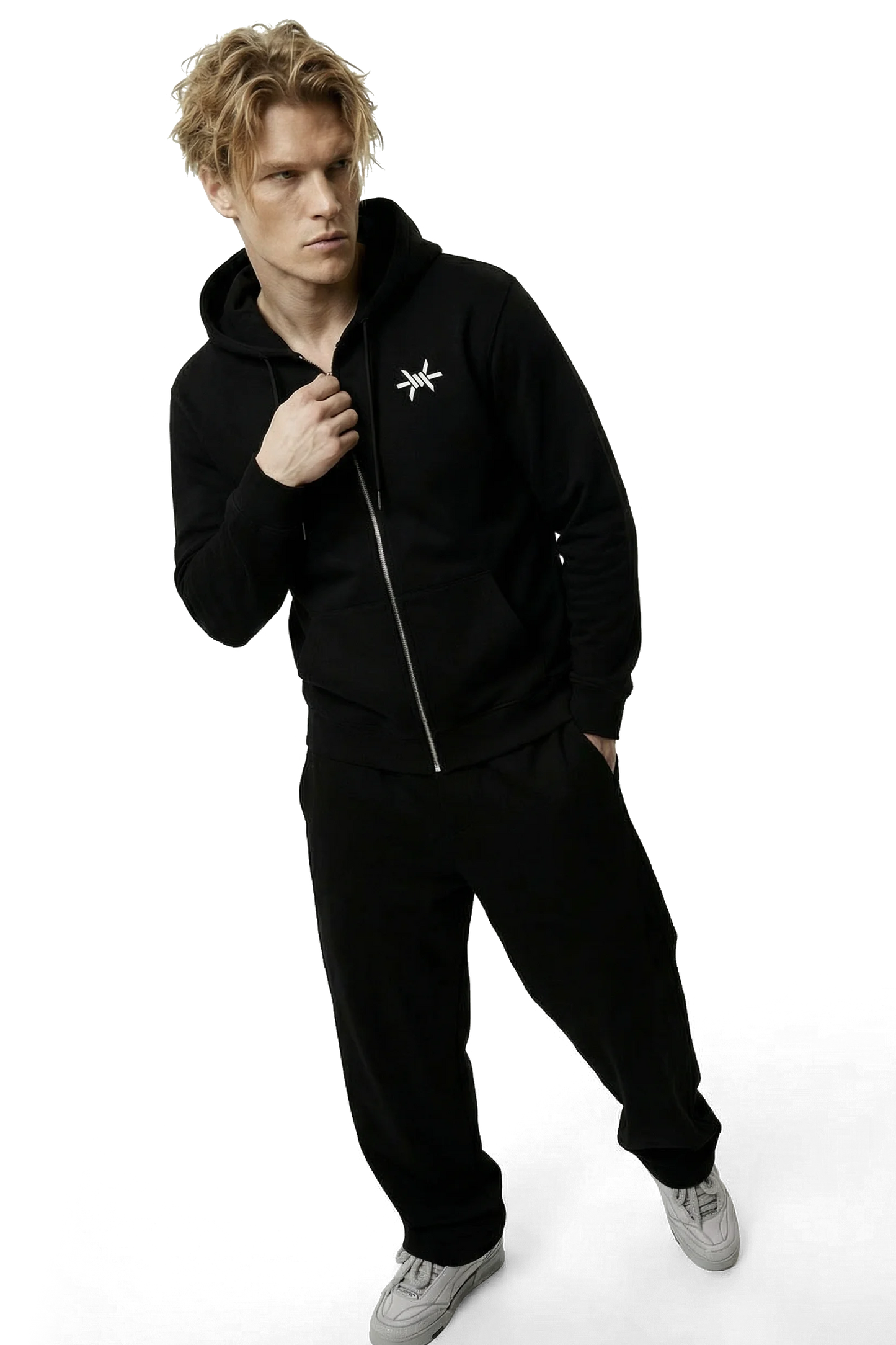 Person wearing a black tracksuit with a logo on a white background