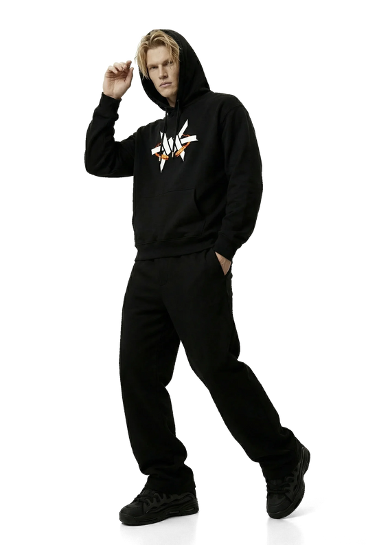 Person wearing a black hoodie with a white logo on a white background