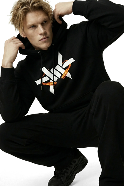 Person wearing a black hoodie with a logo on a white background
