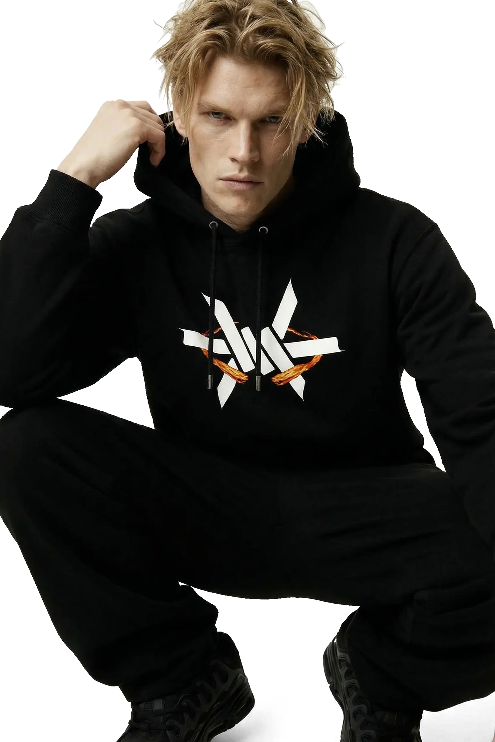 Person squatting down wearing a black hoodie with a large white 'Ominous' luxury brand logo on a white background