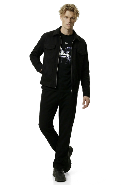 Man wearing a black suede lounge overshirt and pants with a black graphic t-shirt on a white background