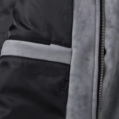 Close up of the inside of a gray suede lounge mens overshirt jacket showing suede, metal zipper and black silk inner